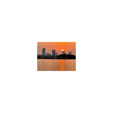 Cityscape with silhouette of skyscraper and river on sunset background.の写真素材