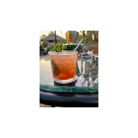 Cocktail in a restaurant on the background of the summer landscapeの写真素材