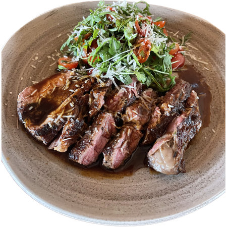 beef steak with salad on a plate isolated on a white backgroundの写真素材