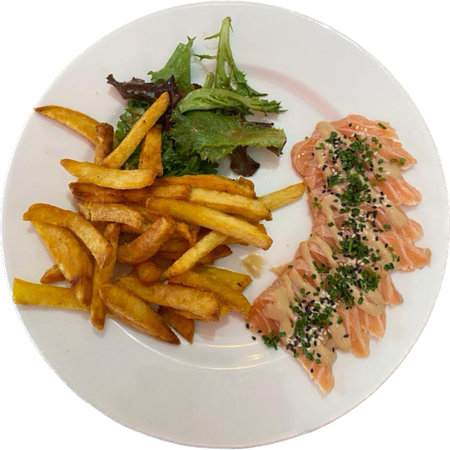 Salmon salad with french fries on a white plate isolated on white backgroundの写真素材