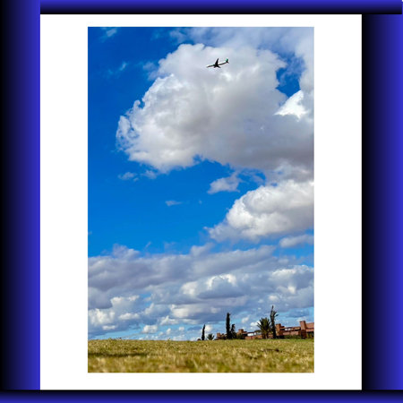 Landscape with blue sky, white clouds and plane. Collage.の写真素材