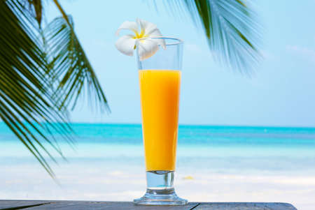 glass of juice with a view of the sea.