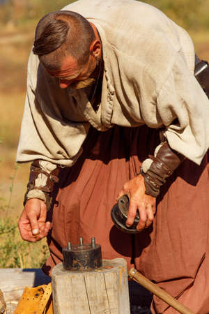 Old Cossack ready to coin money on the island of Khortytsya. Zaporozhye, Ukraineのeditorial素材