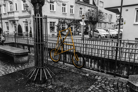 Augsburg, Germany, January 31, 2018. Yellow bike on the street in old part of town Augsburg.のeditorial素材