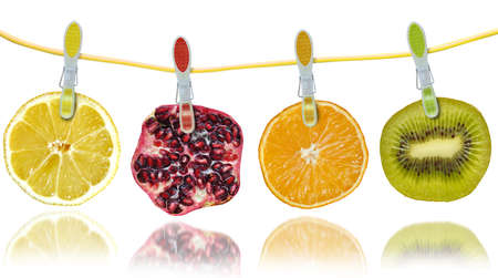 Slices of citrus fruits hanging on a stringの写真素材