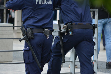 Police officers during the service against the background of greenery.