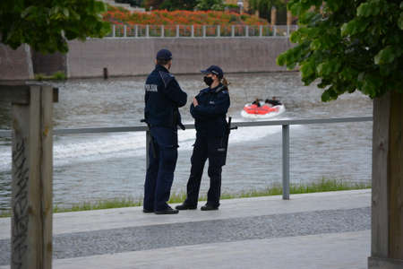 Police officers during the service against the background of greenery.のeditorial素材