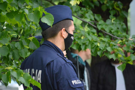 Police officers during the service against the background of greenery.