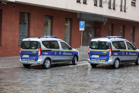 A police car of the city guard patrols the city in the rain.のeditorial素材