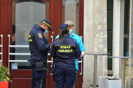 05.03.2021, wroclaw, poland, City guard on a patrol in the old town during a pandemic. City guard...