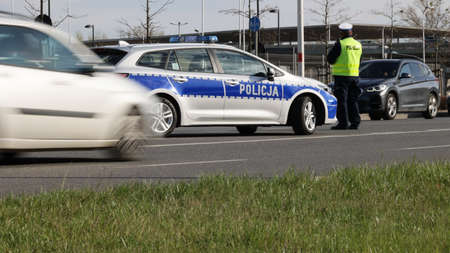 A traffic policeman with his police car controls the traffic in the city.のeditorial素材