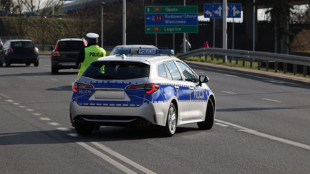 A new police car of the Polish police on the road in the city.のeditorial素材