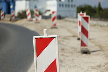 Warning bollards at the construction of a new road in the city.