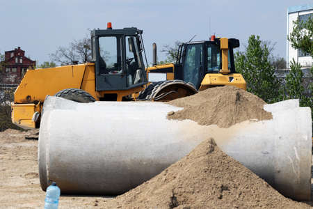 Yellow excavator at the construction site of a new road in Poland.