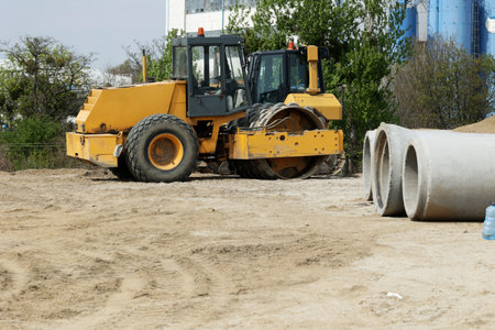 Yellow excavator at the construction site of a new road in Poland.