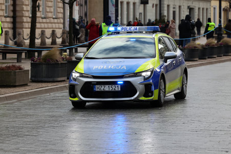 02.21.2023 Warsaw, poland, Polish police yellow-blue police car, while on duty in the city. New colors.のeditorial素材