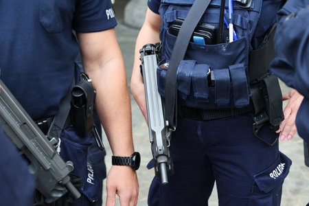 Detail of a group of police officers holding a gun in the streetのeditorial素材