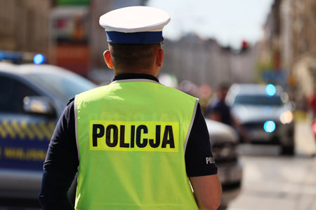 A traffic policeman in white gloves directs traffic in the city. Poland Wroclaw.のeditorial素材