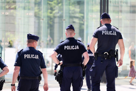 A traffic policeman in white gloves directs traffic in the city. Poland Wroclaw.
