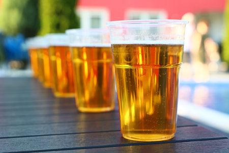 Beer glasses on a wooden table in a restaurant, close-upの写真素材
