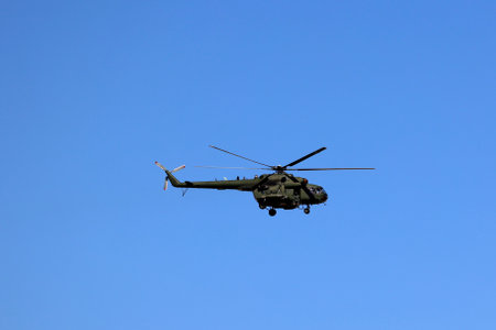 Helicopter air show. Military parade on the Polish Army Day Warsaw 2023. Aviation., Military helicopter flying in the blue sky.のeditorial素材