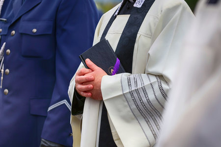 Jewish man with a bible in the hands of a priest during a religious ceremony