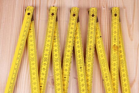 Yellow wooden meter on the the wooden background