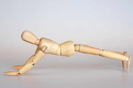 Wooden mannequin doing push ups