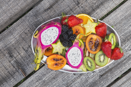 Fresh fruit salad on a grey wooden tableの写真素材