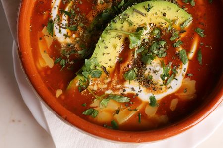 Tortilla Soup with fresh avocado and creamの写真素材