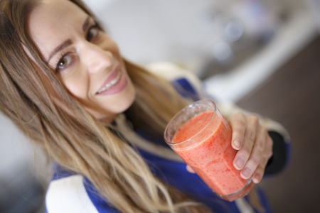 Attractive Girl in Sportswear Drinking Tasty Smoothieの写真素材