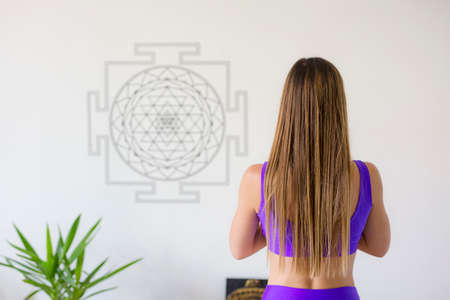 Woman meditating and relaxing in yoga studio