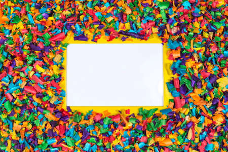Creative layout made of colorful sawdust around yellow frame with empty space for text