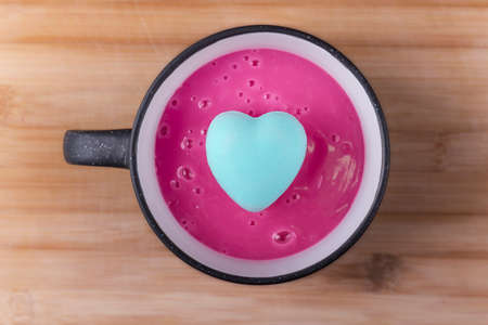 Hot raspberry pudding in a cup with light blue heart