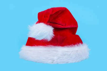 Red Santa hat on light blue background