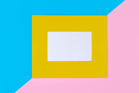 Simple yellow frame on pastel pink and blue background with copy space. Minimal border composition.の写真素材