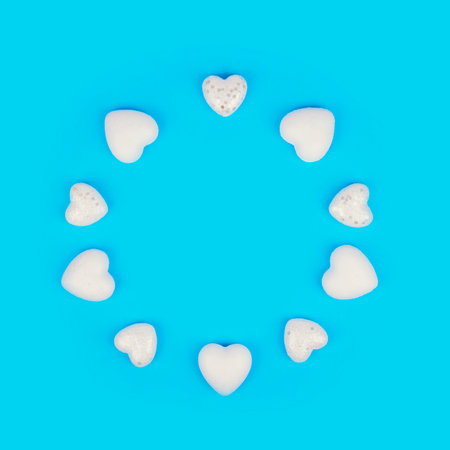 Minimal composition with white hearts on pastel blue background. Valentines day concept.