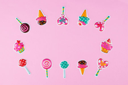 Layout of various candy stickers on pastel pink background with copy space.の写真素材