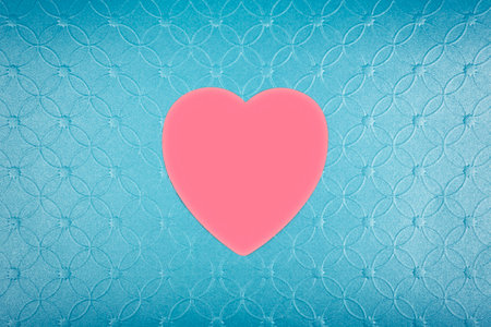 Pink heart on pastel textured blue background. Minimal Valentines day concept.