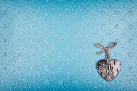 Grunge heart with rope bow on blue textured backgroundの写真素材