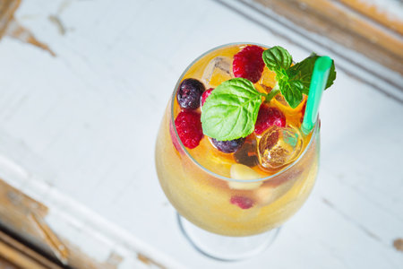 Cold and fresh white sangria with mint in wine glassの写真素材