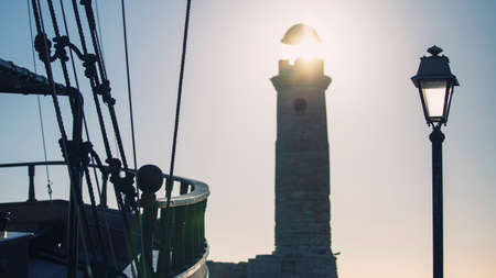 View of the lighthouse on the island of Rhodes, Greece at sunsetの写真素材