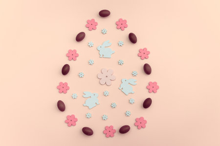 Flat-lay Easter decoration wooden flowers, rabbits and eggs on pastel background. Copy space.の写真素材