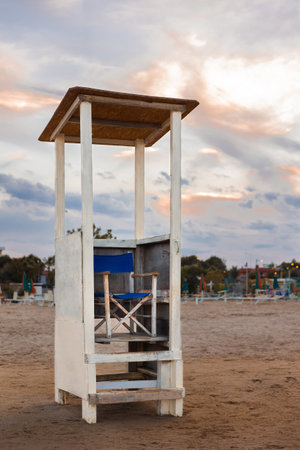 Rescue tower. Vacation concept. Empty sea beach. Sunset at a lifeguard tower in Italyの写真素材