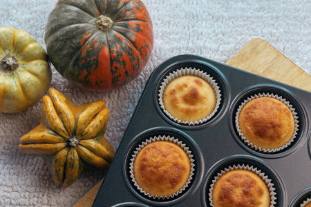 Top view and close up group homemade pumpkin muffins on wooden plank. Autumn dessert and recipesの写真素材