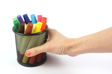 colored markers in hand on the white backgroundの写真素材