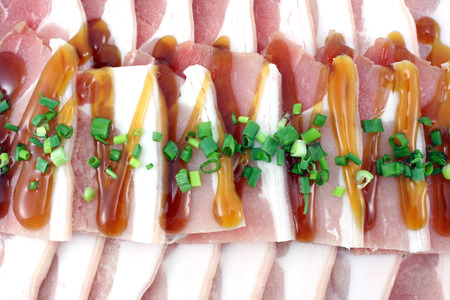Bacon, streaky pork slice on white backgroundの写真素材