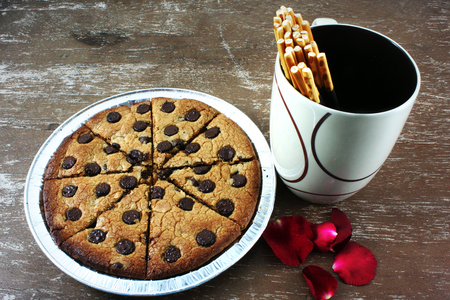 soft chocolate chip cookies with Rose petals and chocolate coated biscuit sticksの写真素材
