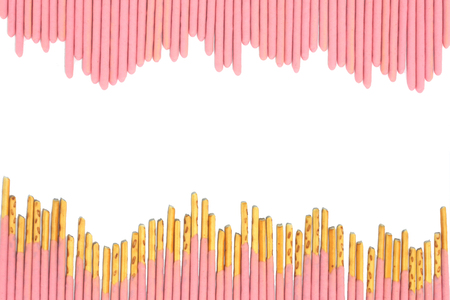 strawbery coated biscuit sticks on white backgroundの写真素材