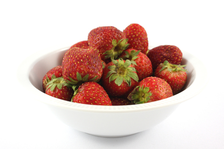 rotten old strawberry in white blow on white backgroundの写真素材